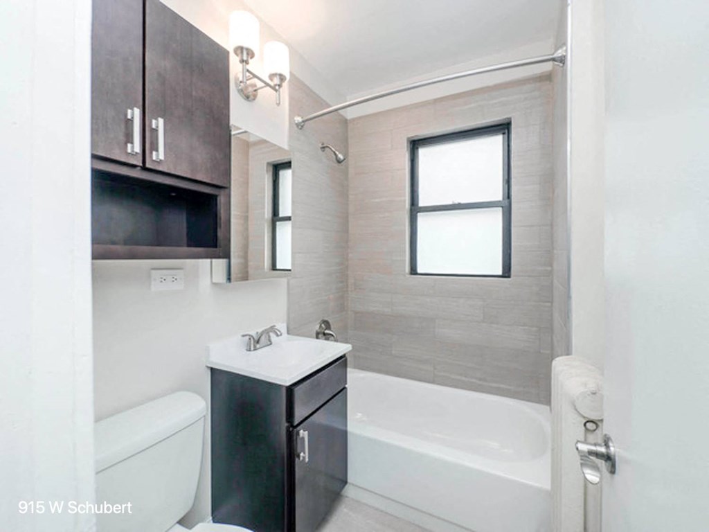 a bathroom with a tub and a sink and a mirror