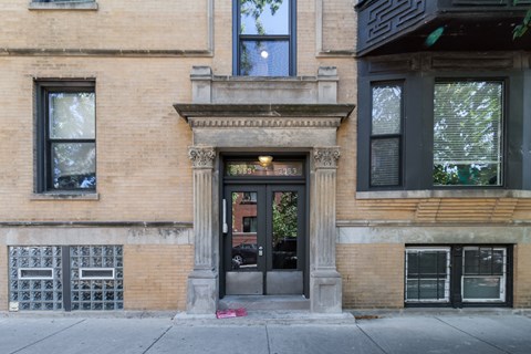 A brown building with a black door and windows.
