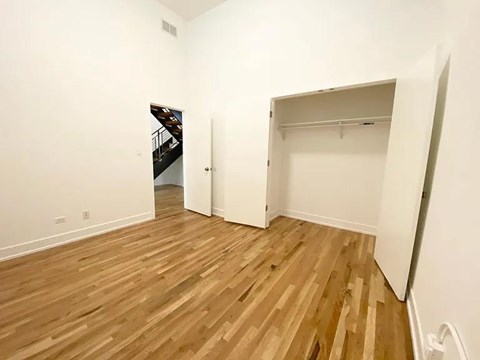 A room with a white wall and a wooden floor.
