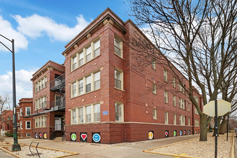 a red brick apartment building on a city street