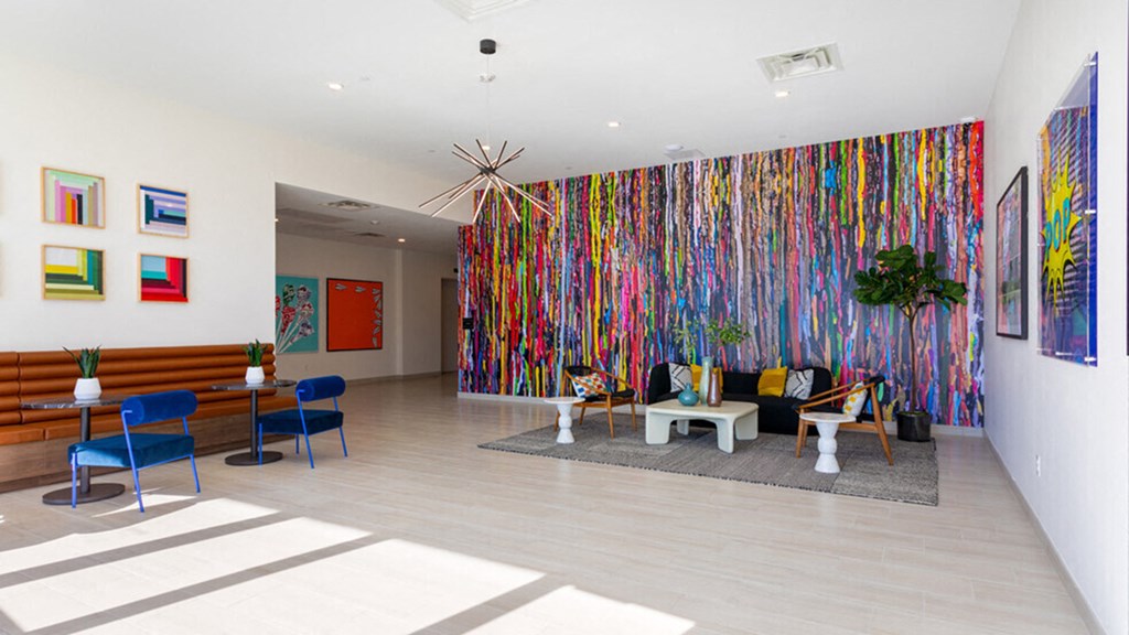 the lobby of a building with a colorful wall and furniture
