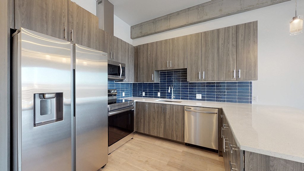 a kitchen with stainless steel appliances and a counter top
