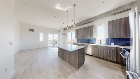 A spacious kitchen with wooden cabinets and a large island.