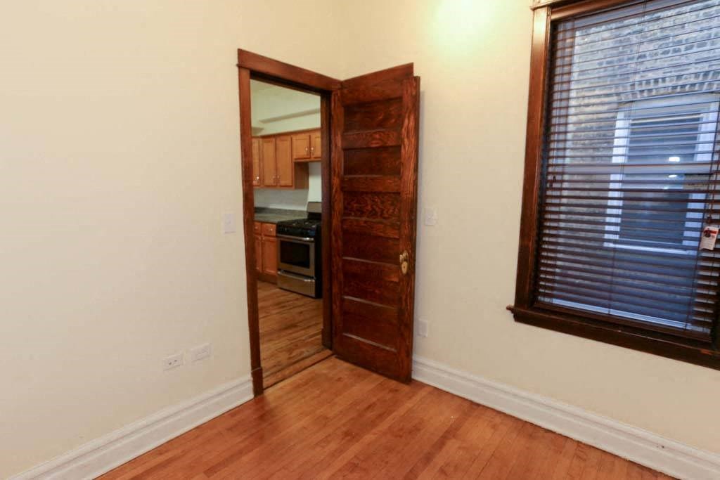 a hallway with a door and a mirror in a house