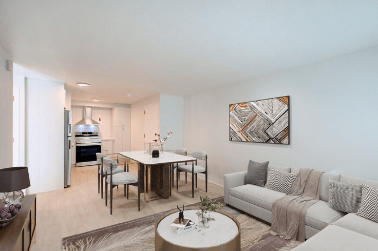 a living room with a couch and a table with chairs