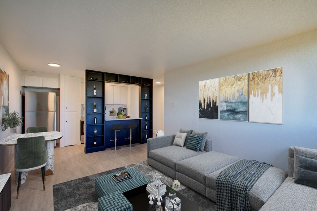 a living room and kitchen with a couch and a table