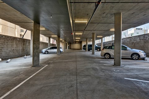 an empty parking garage with cars parked in it