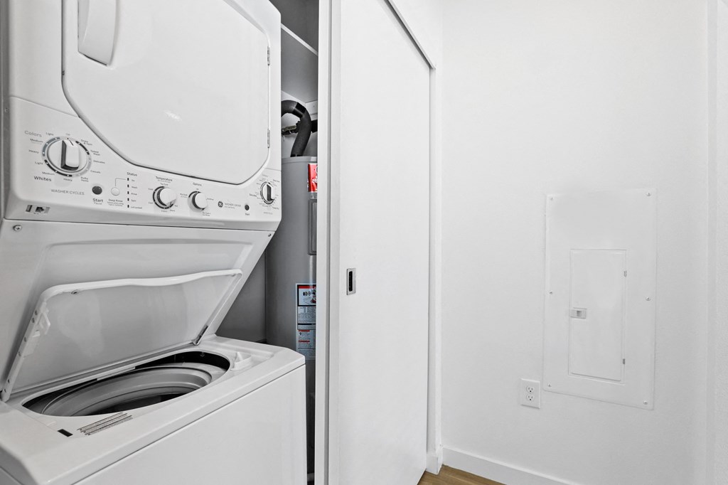 a white laundry room with a washer and dryer