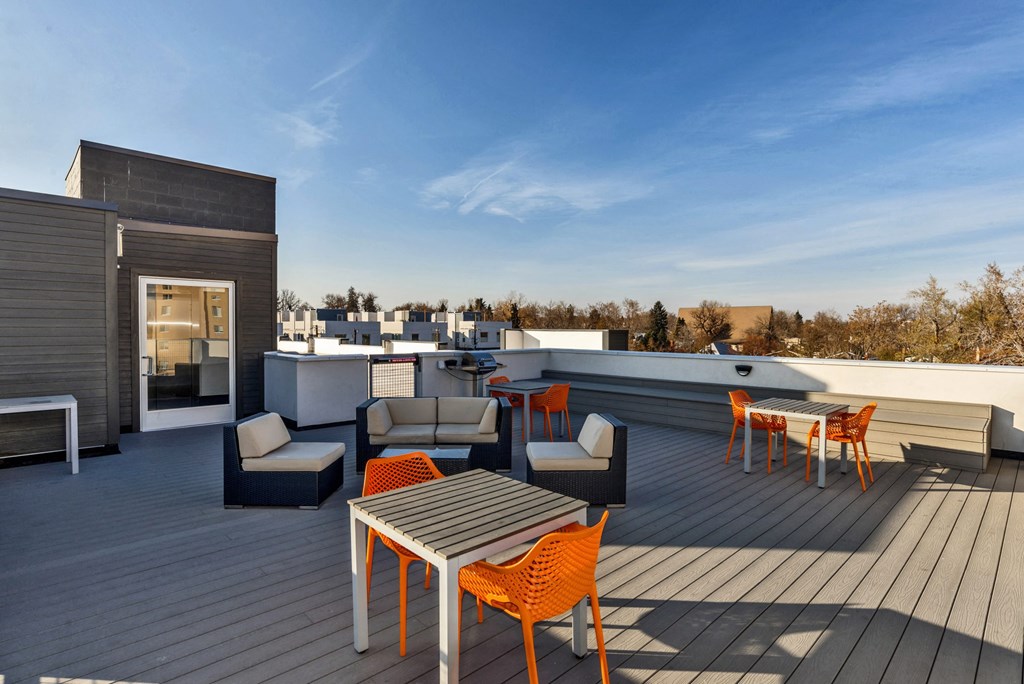 a roof deck with furniture and a view of the city