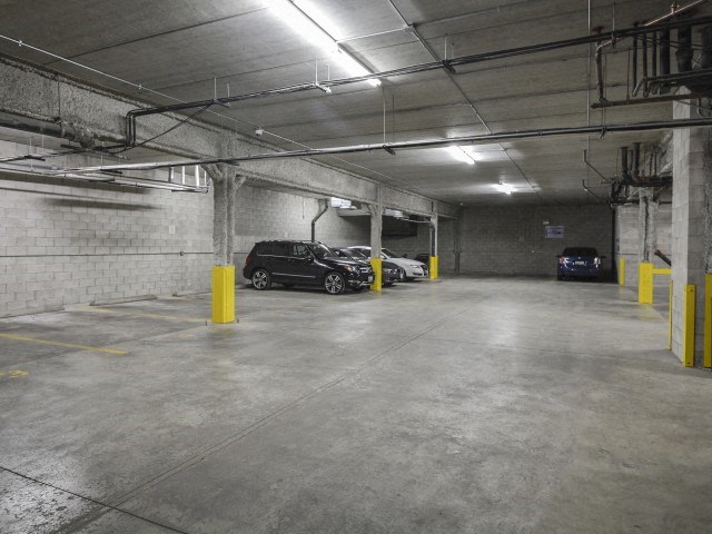 a large parking garage with cars parked in it
