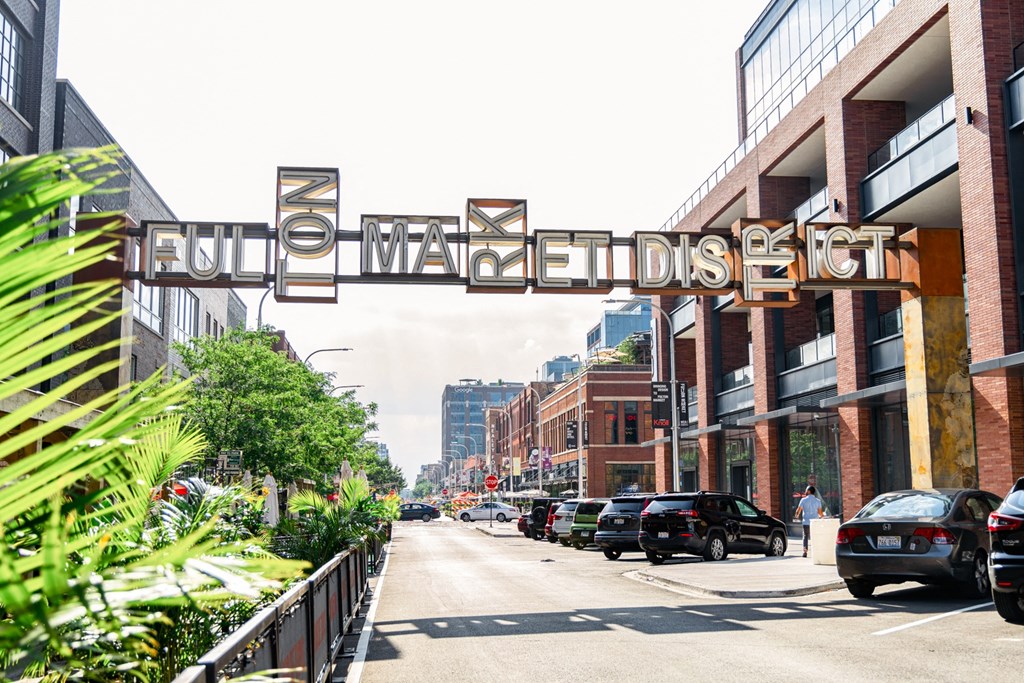 a city street with a sign that reads fuqua avenue in front of some buildings