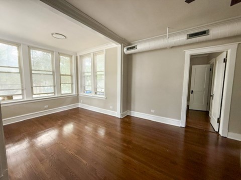 A room with wood floors and white walls.