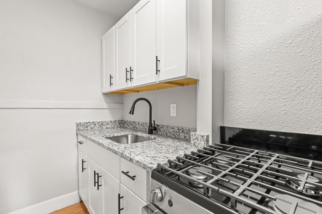 the kitchen of our studio apartment atrium with stove and sink