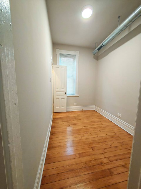A room with wooden floors and white walls.