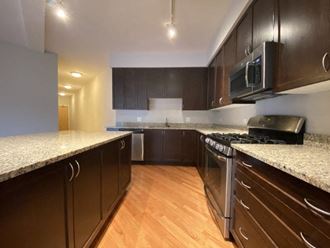 a kitchen with a stove top oven and a microwave