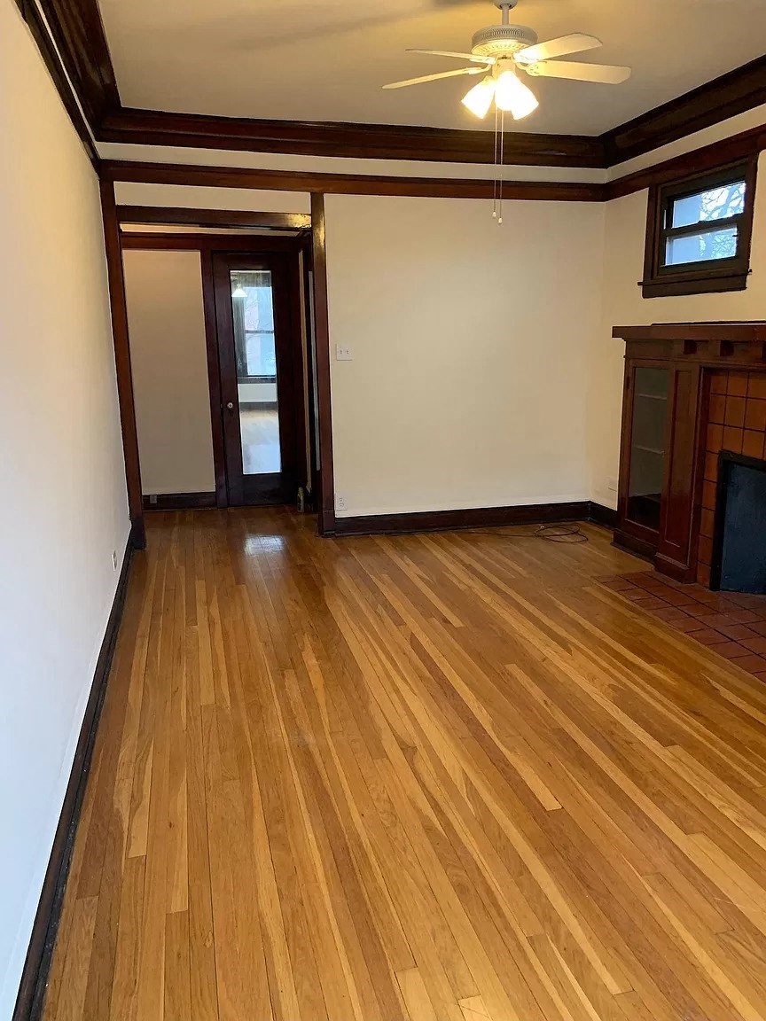 a living room with wooden floors and a fireplace