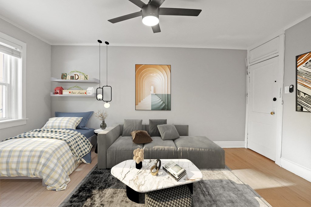 a living room and bedroom with a bed and a ceiling fan