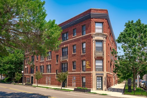 a red brick building on the side of a street