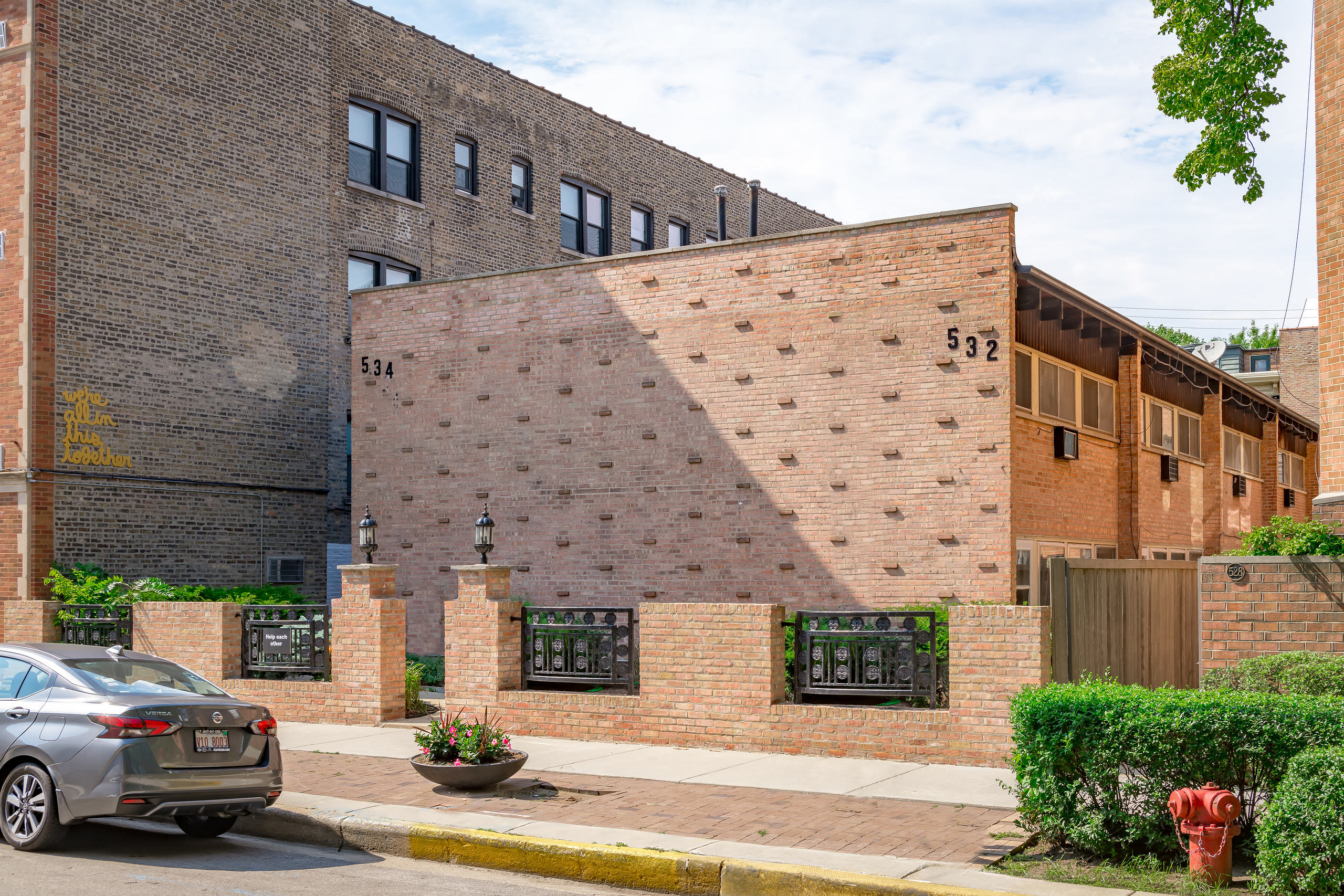 the side of a brick building with a large shadow on it
