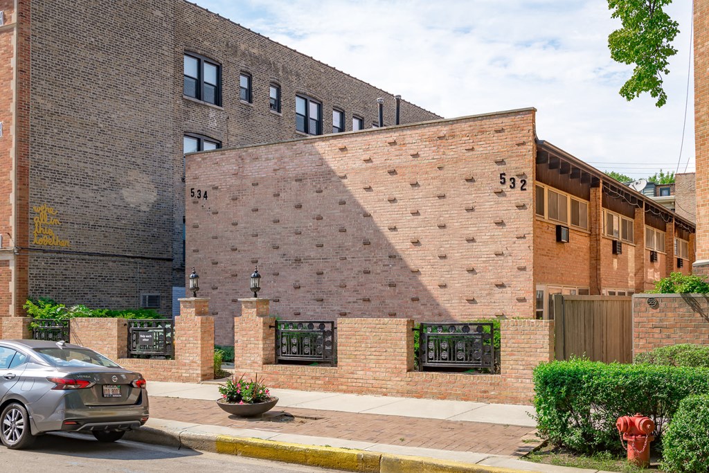 the side of a brick building with a large shadow on it