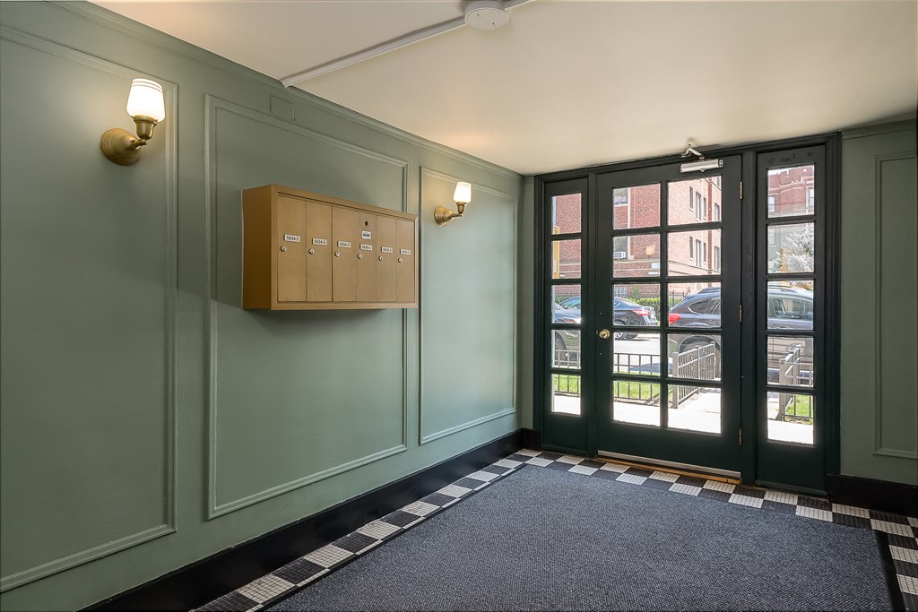 the entrance to a room with a door and a cabinet on the wall