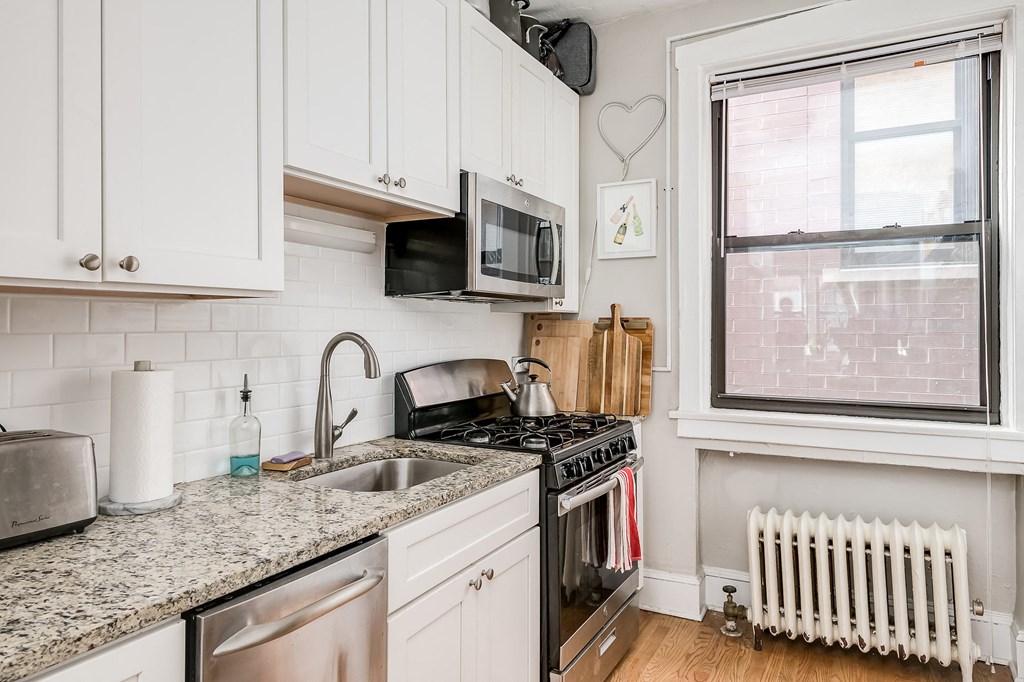 a kitchen with a sink and a stove and a window