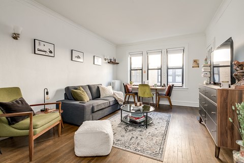 a living room with a couch and a glass coffee table