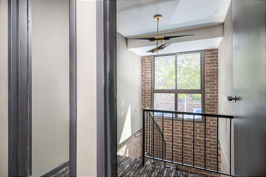 a view of the top of a staircase in a building with a large window