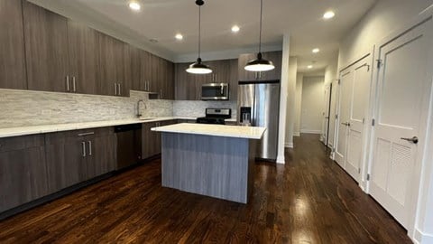 a large kitchen with a white counter top