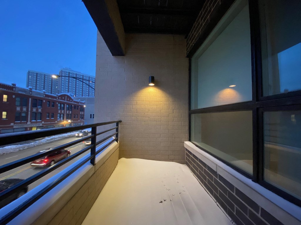 a balcony with a view of a city at night