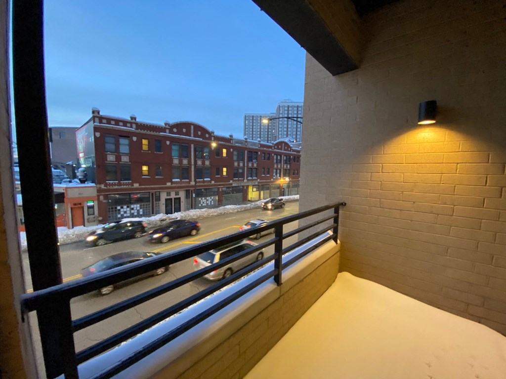 a balcony with a view of a city at night