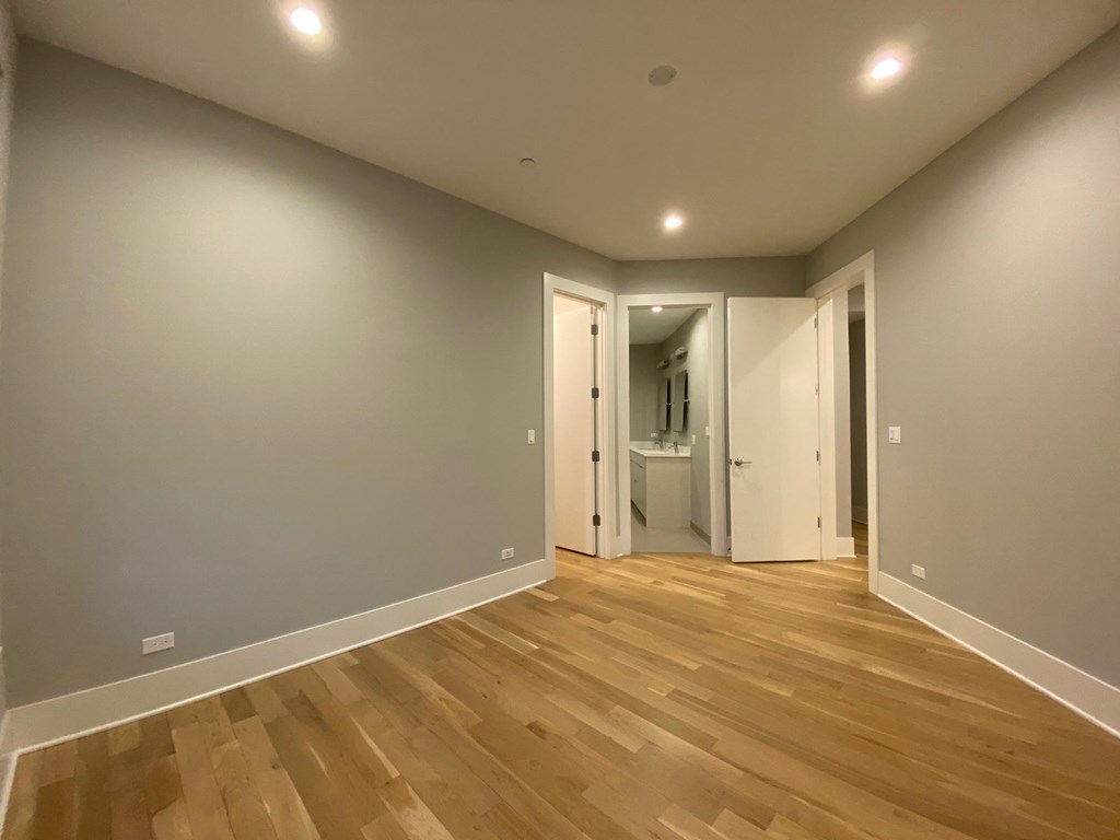 a living room with grey walls and wooden floors