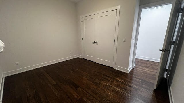 a empty room with a door and a wooden floor