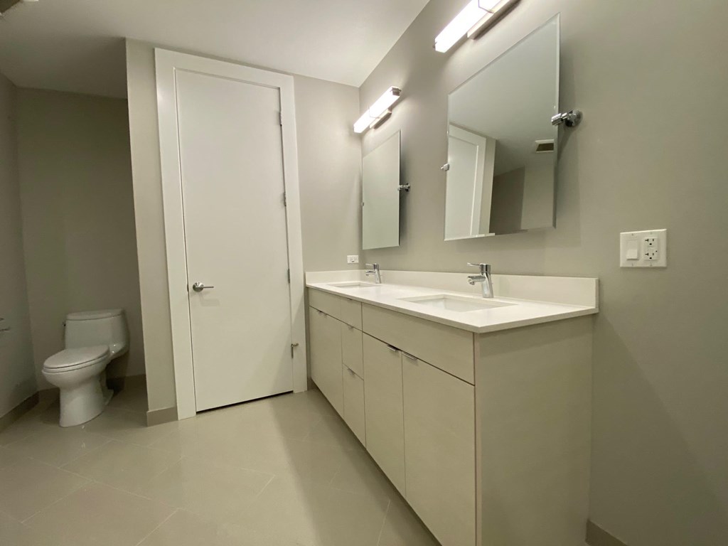 a bathroom with a sink and a toilet and a mirror