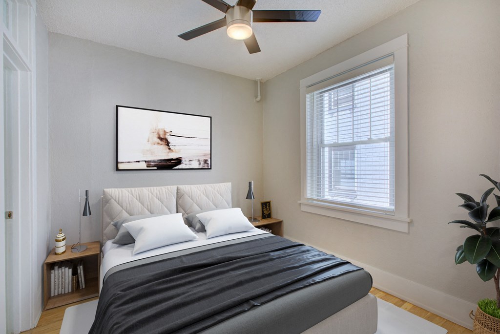 a bedroom with a large bed and a ceiling fan