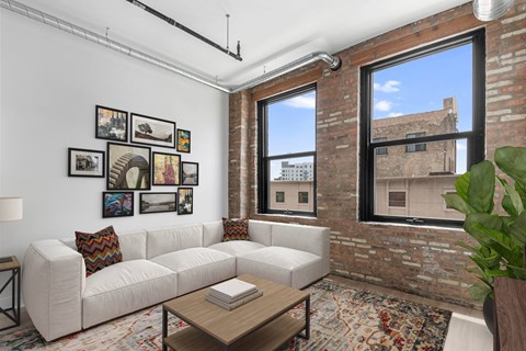 A living room with a white couch and a coffee table.