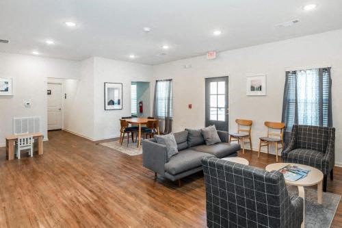 a living room with a couch and chairs and a table