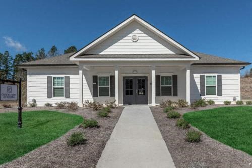 a white house with a sidewalk in front of it