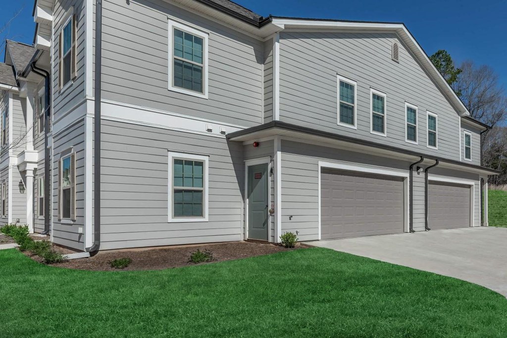 a white house with a driveway and a garage door