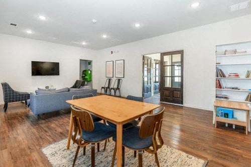 a living room with a wooden table and chairs