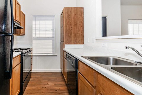 a kitchen with a sink and a stove and a refrigerator