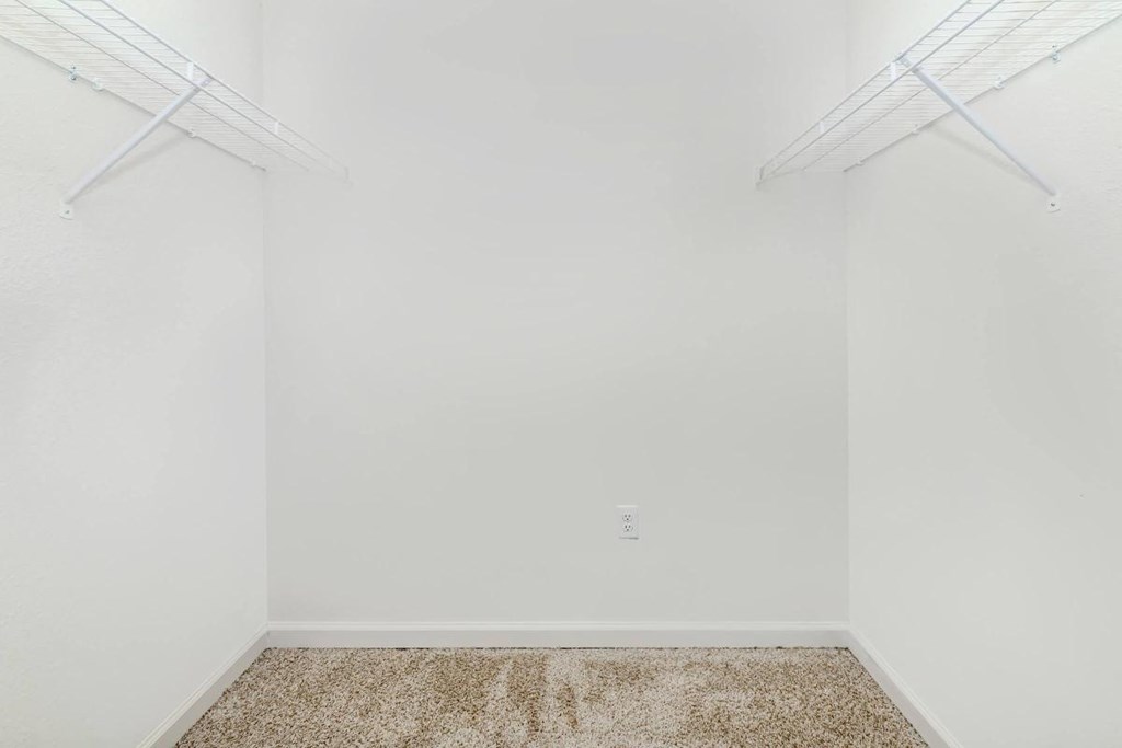 an empty room with white walls and a carpet