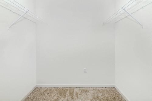 an empty room with white walls and a carpet