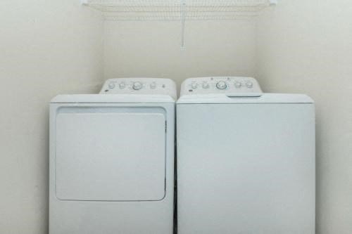 a white washer and dryer in a white room