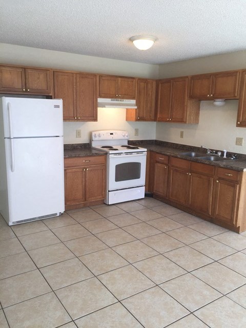 a kitchen with a stove and a refrigerator