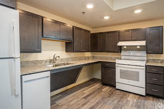 a kitchen with white appliances and wooden cabinets