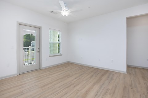 A room with a wooden floor and a ceiling fan.