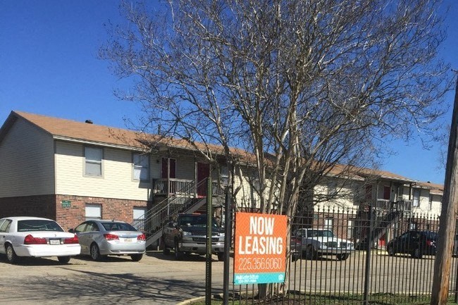 a now leasing sign in front of a house
