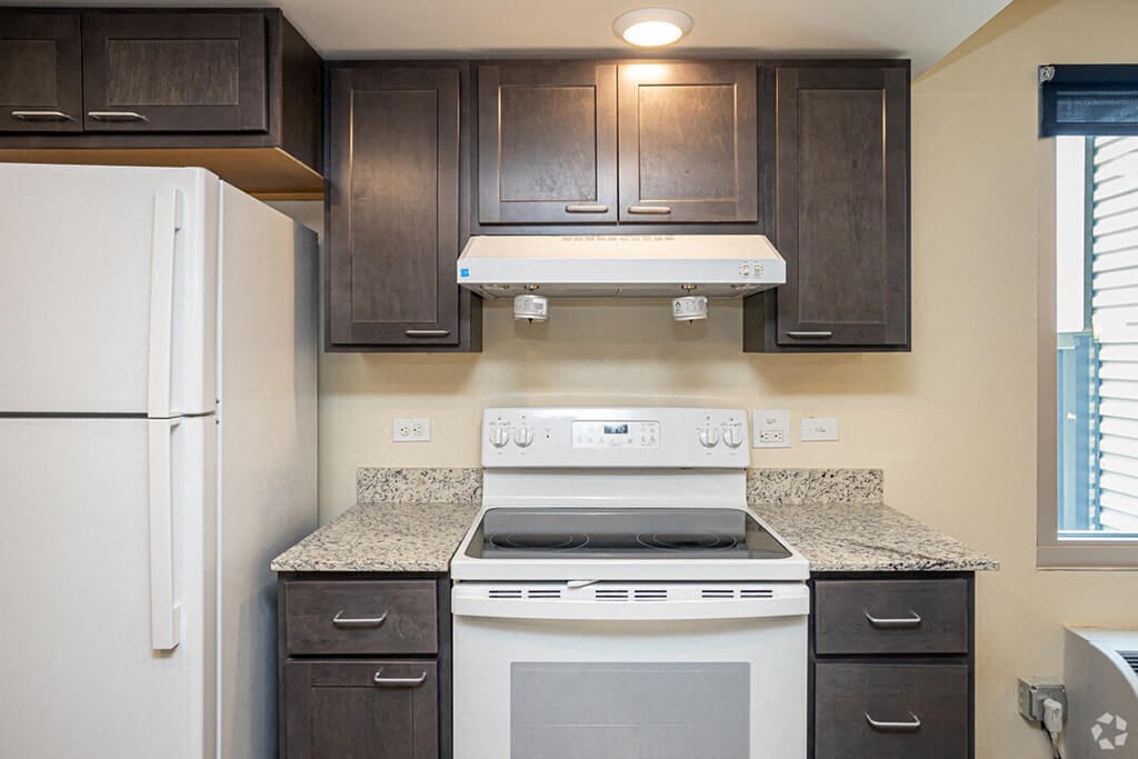 a kitchen with a white stove and a refrigerator