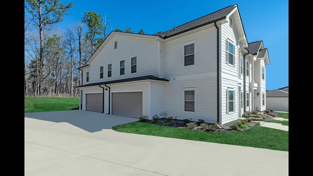 side view of white townhouse and 2 car garage